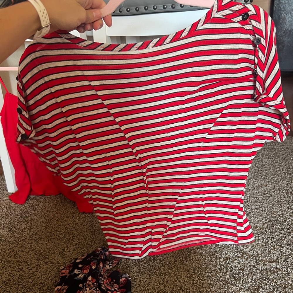 Small red black and white striped shirt with buttons on the sleeves